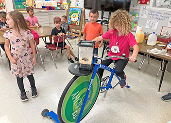  Student riding the smoothie blender bike during Fit for Life event